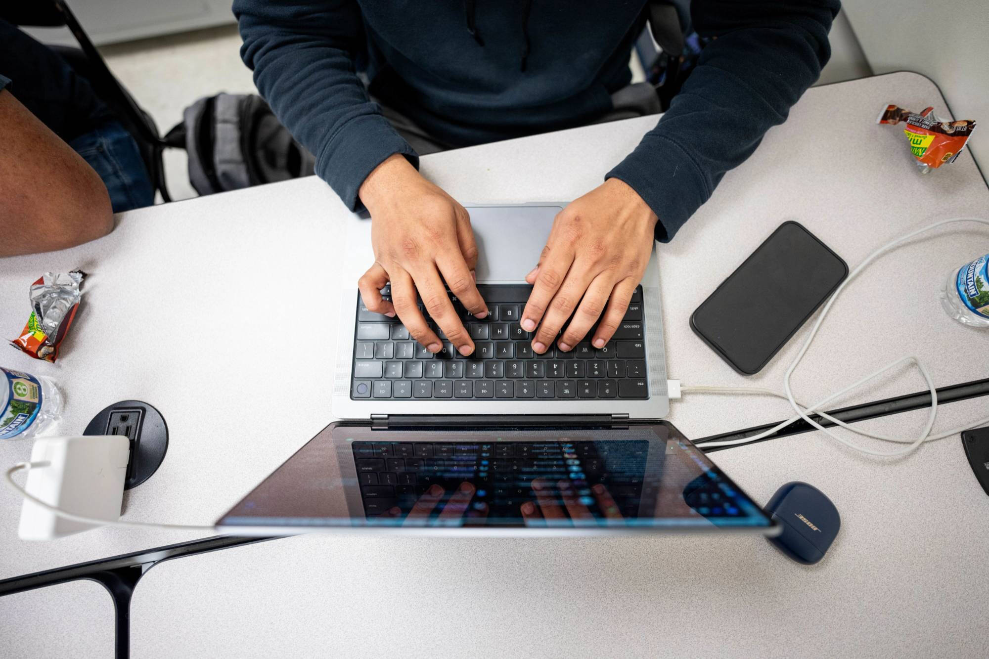 Top-down view of a student using their laptop
